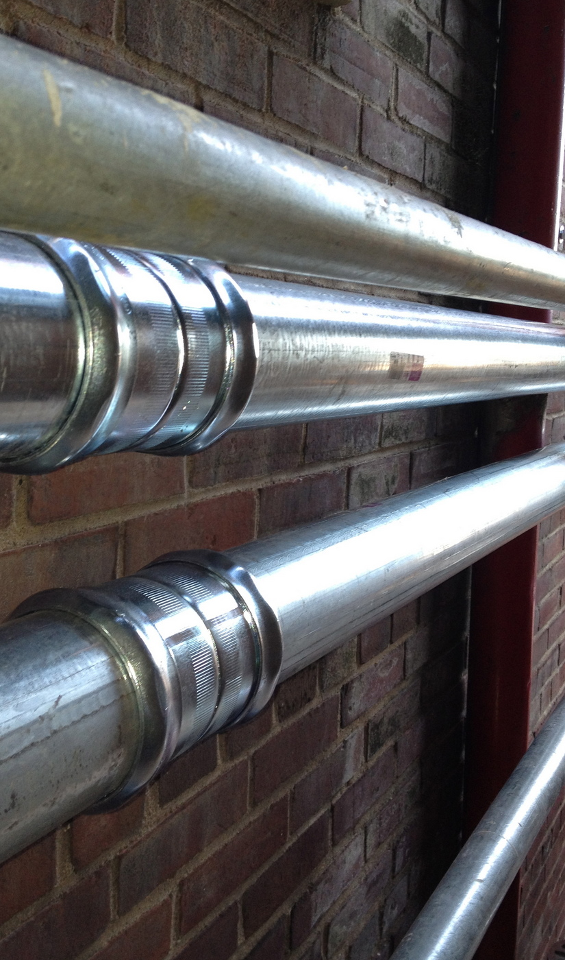 Picture of conduite attached to brick wall